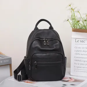 Black leather backpack detail, large capacity casual daypack with multiple zipper pockets.