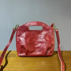 Vintage genuine leather women crossbody handbag, retro wine red shoulder bucket bag style.