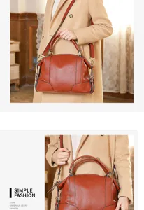 Detailed view of the stylish brown genuine leather handbag, featuring top handle and strap.