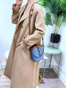 Genuine leather women bucket bag detail, stylish color-block crossbody bag with chain and lock.