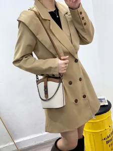 Detailed view of the genuine leather colorblock bucket bag with trendy chain strap and lock.