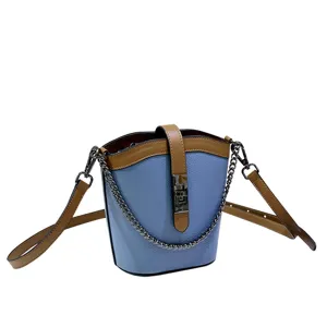 Trendy genuine leather color-contrast bucket bag with chain strap and metal lock closure.