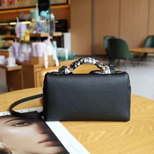 Black leather top handle bag with twilly scarf, stylish small crossbody box bag for women.