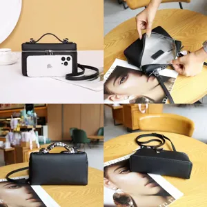 Black leather box bag for women, stylish top handle cosmetic bag with crossbody strap.