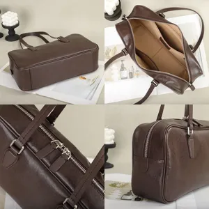 Leather handbag detail showing smooth zipper, structured brown body, and spacious interior compartments.