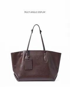 Detail view of the brown leather tote bag showcasing its large capacity and sleek design.