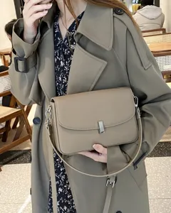 Detailed view of genuine leather shoulder bag in khaki grey, premium cowhide crossbody style.