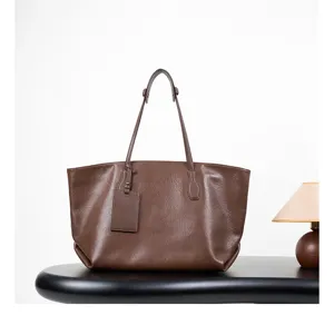 Close-up detail of the premium brown leather tote bag showing fine texture and exquisite craftsmanship.