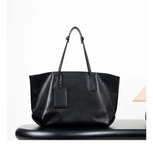 Detail shot of black leather tote bag, large capacity shoulder bag for women commuting.