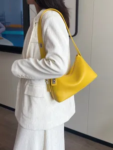 Yellow genuine leather shoulder bag for women, stylish French underarm pillow handbag with pebble.
