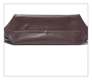 Close-up detail of the dark brown genuine leather tote bag bottom, fine stitching craft.