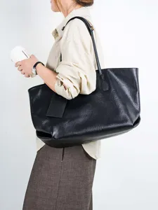 Large capacity black leather tote bag for women, stylish minimalist commuter shoulder bag.