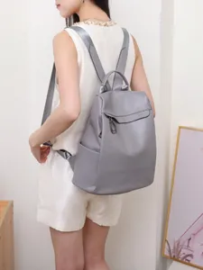 Stylish grey leather backpack for women, casual soft daypack for daily commute use.