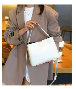 Stylish white leather bucket bag for women, versatile crossbody handbag with top handle.