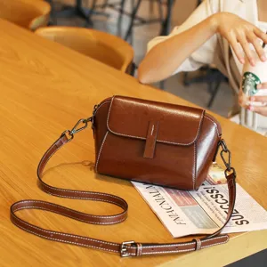 Classic brown leather crossbody bag for women, vintage shell shoulder bag with strap.