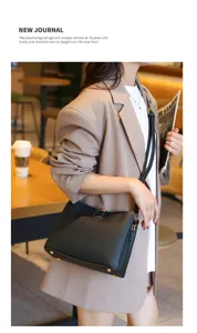 Detailed shot of a chic black leather crossbody bag showcasing exquisite stitching and metal details.