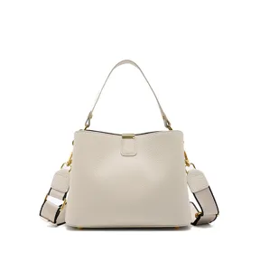 Elegant off-white leather bucket handbag with wide strap detail, high-quality finish.