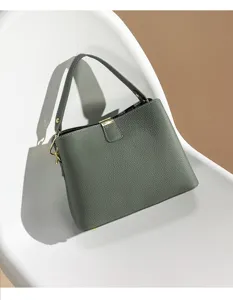 Detailed view of the elegant grey leather top handle bag showcasing fine texture and hardware.