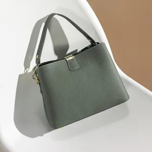 Stylish women's leather crossbody handbag with top handle, elegant niche design for summer.