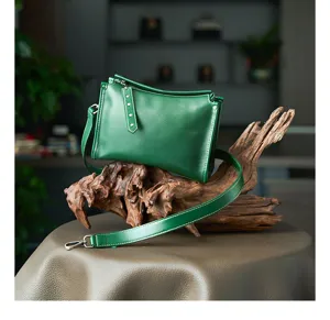Dark green leather crossbody bag detail, vintage genuine leather shoulder bag view.