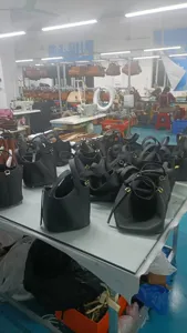 Vue de détail en atelier de sacs seau en cuir fabriqués à la main avec fermoir en métal élégant.