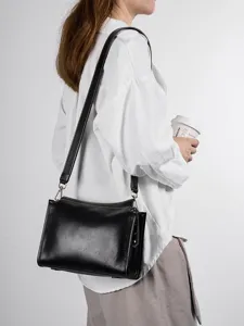 Genuine leather black shoulder bag for women, retro crossbody pillow bag with adjustable strap.