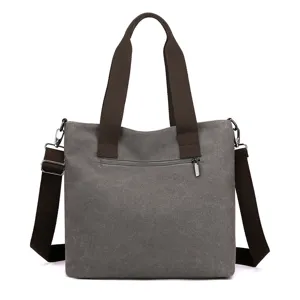 Grey canvas tote bag for women with brown handles and shoulder strap, casual everyday handbag.