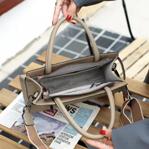 Sac a main en cuir veritable avec poignee superieure et bandouliere pour le travail quotidien.