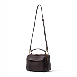 Detailed view of the dark brown leather crossbody bag featuring fine stitching and hardware.