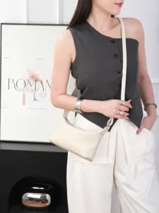 Minimalist beige leather underarm bag detail shot, versatile chic shoulder bag for women daily style.