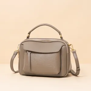 Classic leather shoulder bag for women, stylish top handle boston bag with crossbody strap.