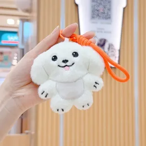 White puppy plush keychain with orange strap, cute toy detail shot for bags and keys.