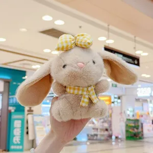 Cute plush bunny pendant detail, fluffy stuffed animal toy with yellow plaid bow and scarf.