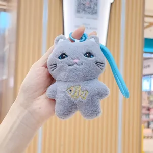 Cute grey cat plush phone pendant detail shot, soft fabric texture with delicate fish embroidery.