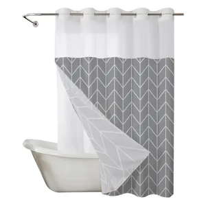 Detail view of the double-layer shower curtain with grey geometric pattern and large rings.