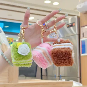 Cute plush cake keychains featuring sweet cream and flower designs, perfect bag charms.