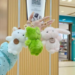 Cute plush animal keychain set featuring rabbit, sheep, and frog dolls. Soft and fluffy detail view.