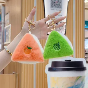 Closeup detail of cute fruit plush keychain, soft triangle pendant with metal hook.