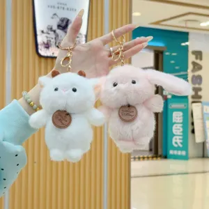 Plush keychain detail featuring cute sheep and rabbit plush pendants with soft fur and rings.