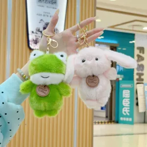 Cute plush frog and bunny keychains detail view, fluffy stuffed animal bag charm pendants.
