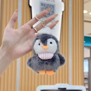 Cute chunky penguin plush toy keychain with a lovely mini hat and striped bib detail.