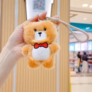 Cute plush bear keychain plushie toy detail, soft stuffed animal bag pendant charm.