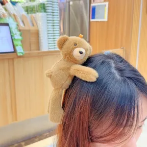 Cute brown teddy bear plush hair clip for women, soft animal duckbill clip for bangs styling.