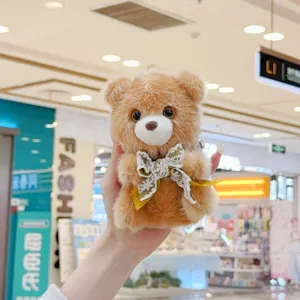Cute teddy bear plush pendant with lace bow, soft stuffed animal keychain for school bag.