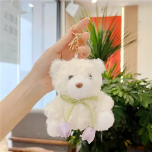 Cute white plush bear keychain with green ribbon and tulip pendant for bags and keys.