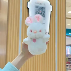 Cute plush rabbit toy detail showing soft white fur, pink inner ears, and a sweet embroidered heart.