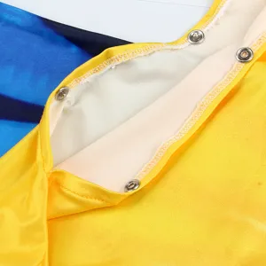 Kids mermaid swimsuit detail featuring yellow fabric and secure metal snap buttons for easy wear.