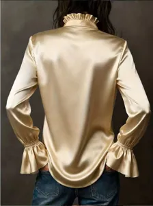 Detailed back view of champagne gold satin shirt with ruffled high neck and bell sleeves.
