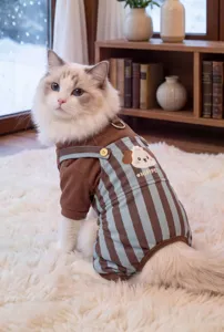 Detailed view of corduroy pet jumpsuit, warm four-leg dog clothes with cute puppy patch.