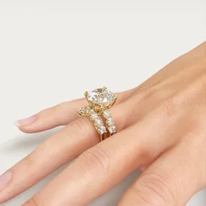 Gold four-prong round diamond ring set detail view, sparkling micro-set zircon hand jewelry.